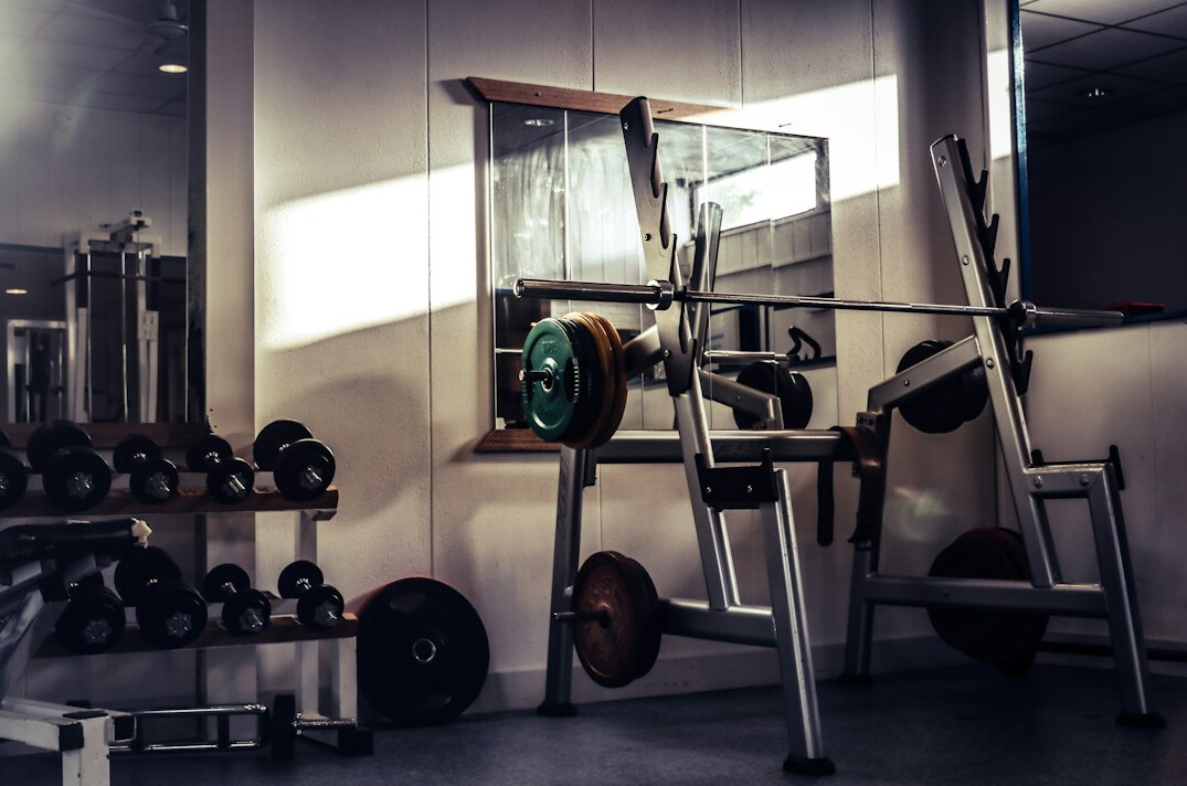 Dumbbells and fitness equipment in a bright gym