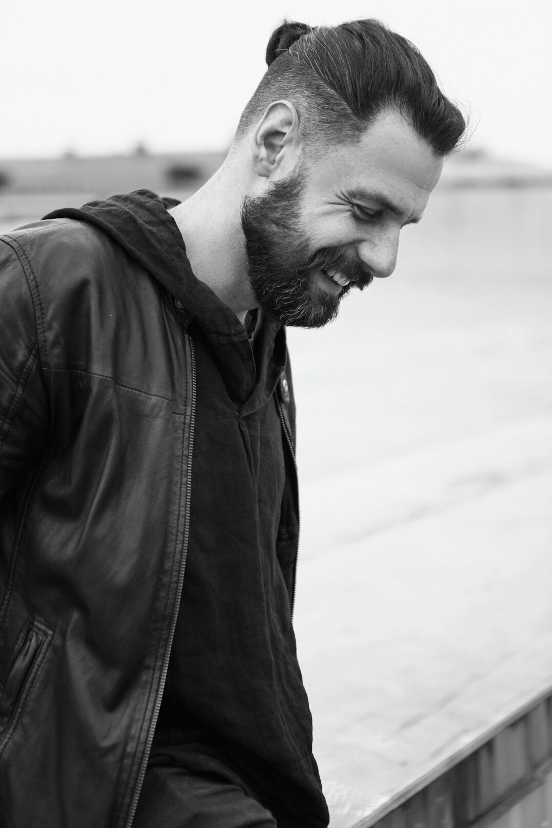 Portrait of a smiling bearded man in a casual outfit